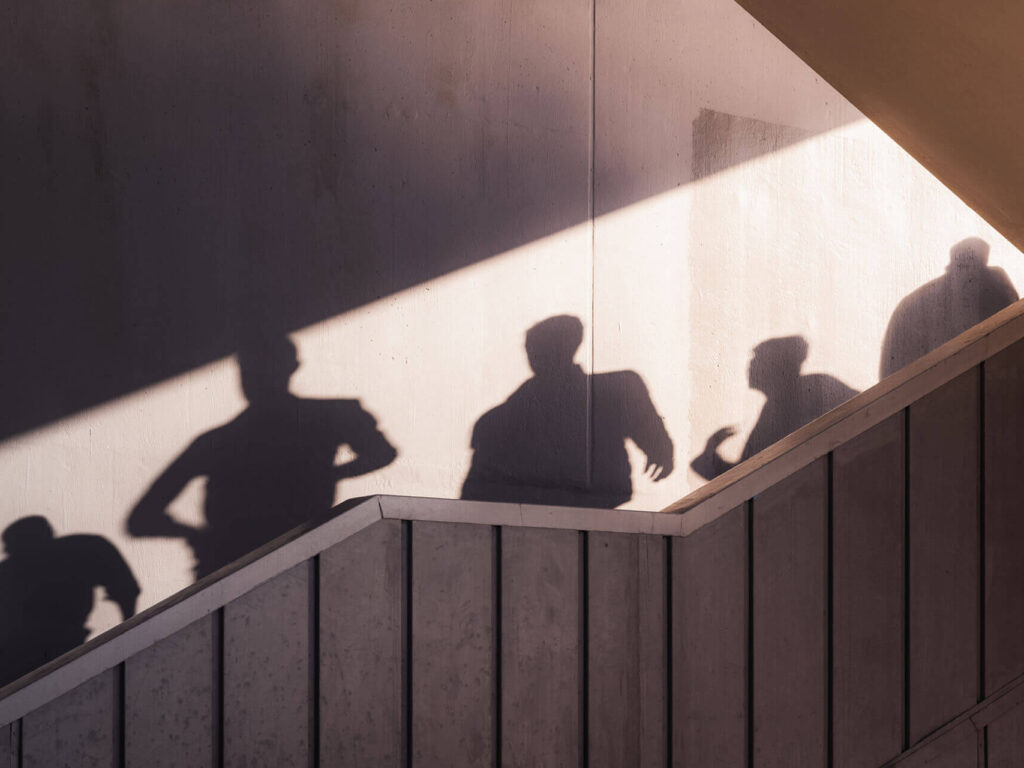 silhouettes moving through a stairwell